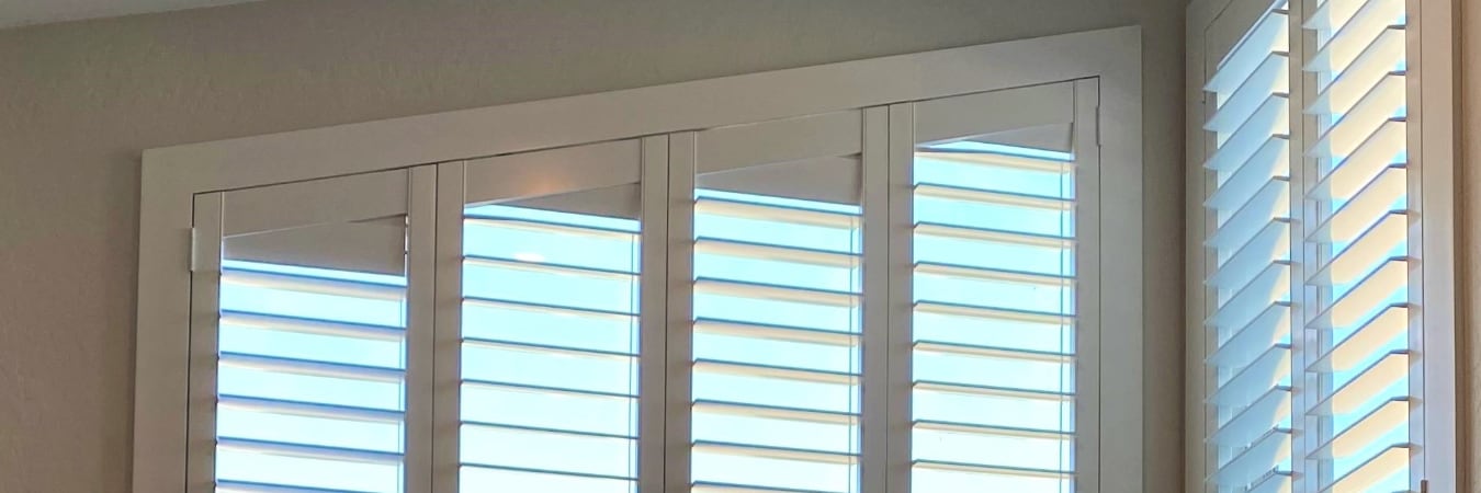 Raked window with plantation shutters